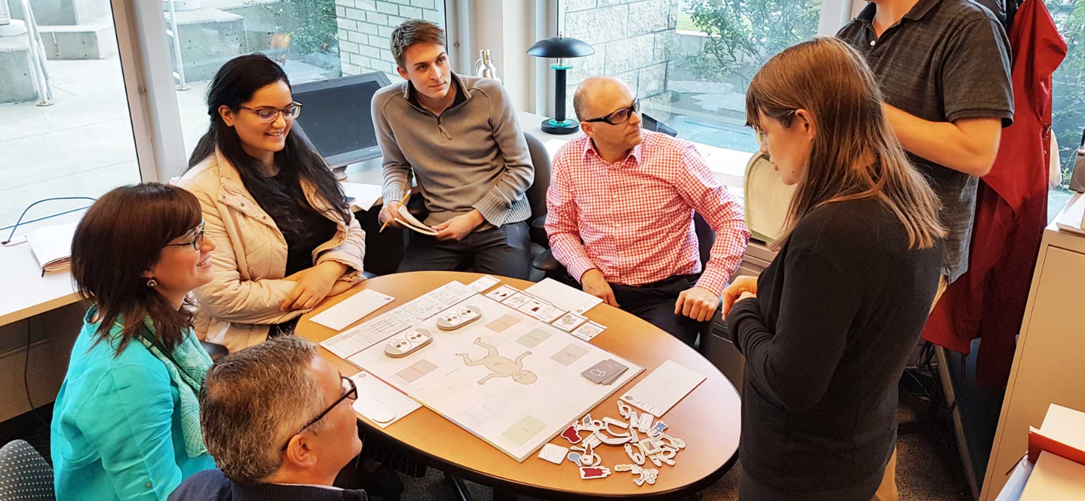 Group playing a board game around a table