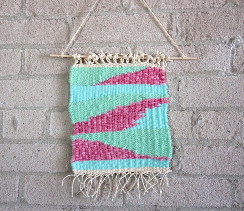 Finished wall-hanging, hanging against a white brick wall