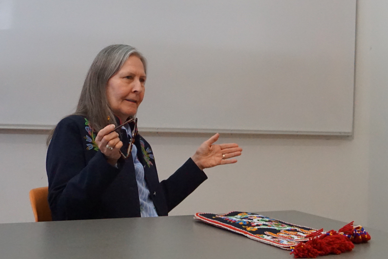 Jennine Krauchi sitting with sample of Metis fire bag