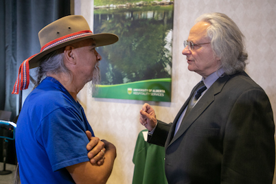 An audience member talks with Keynote presenter Frank Tough