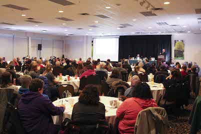 Image of the audience and stage in the Maple Leaf Room