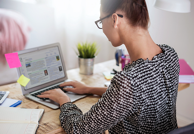 Photo of a woman working on a laptop