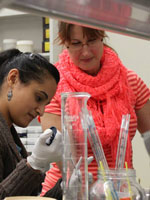 Christine Szymanski works with a grad student in the lab.