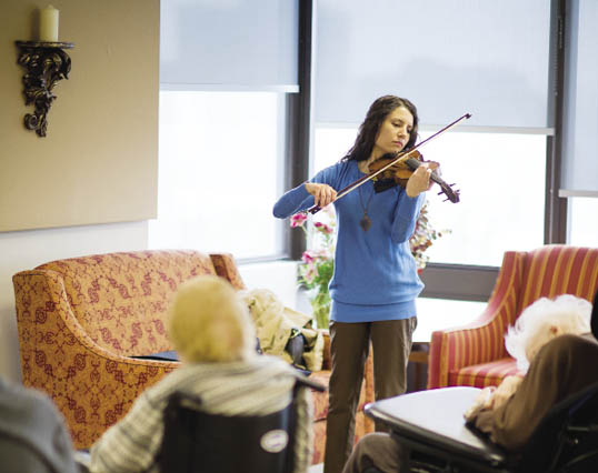 Hannah O Rourke playing violin at seniors home