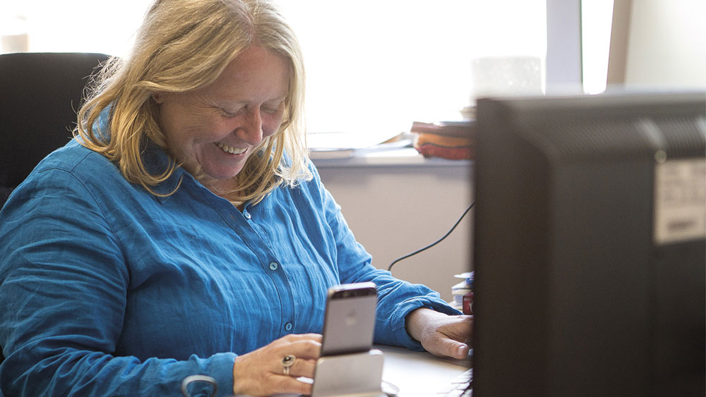 Margaret Evans working at her desk