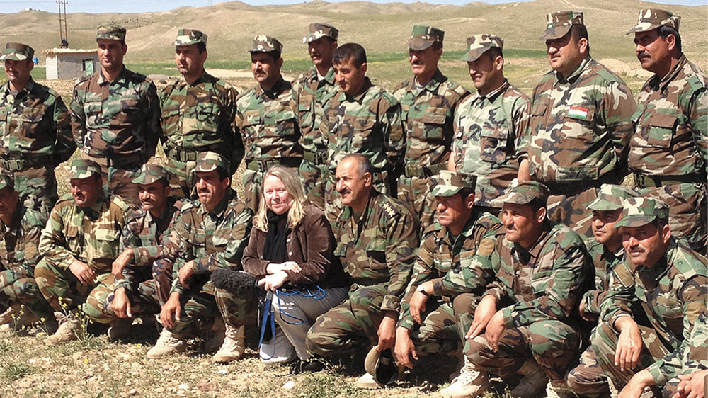 Margaret Evans shown here with Kurdish soldiers in northern Iraq