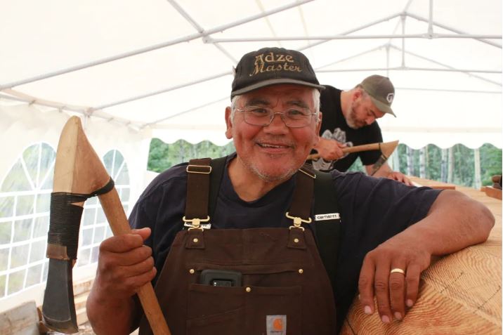 Wayne Price standing with canoe