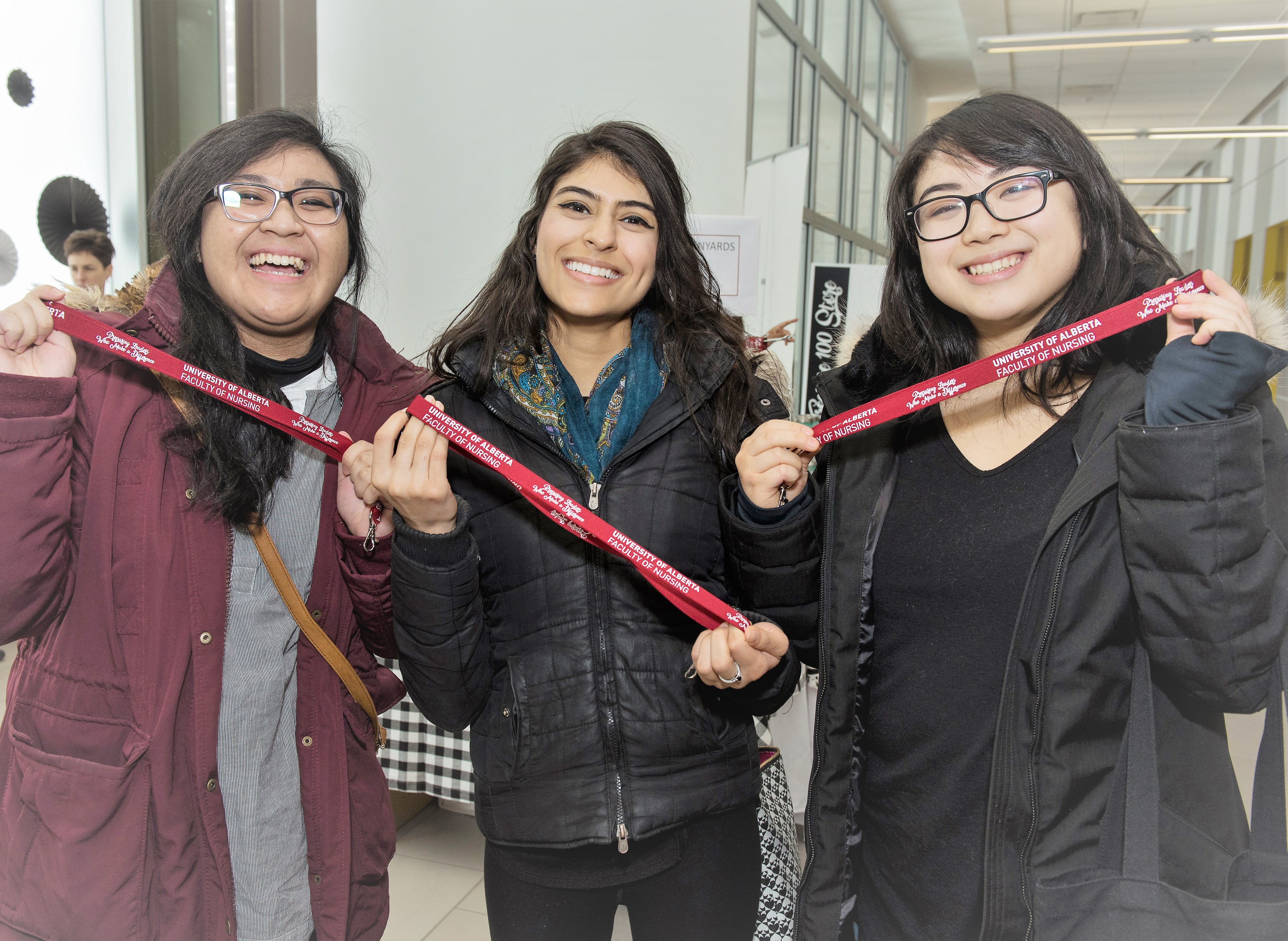 Three women holding medal