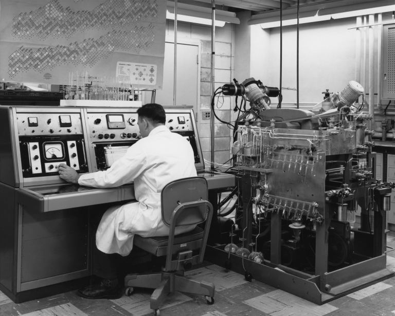 Mass spectroscopy lab, Physics, 1960s. Mass spectroscopes were originally developed to resolve questions about the fundamental nature of the atom. Geochronology establishes the age of rocks based on the measurement of isotopic ratios by mass spectrometry. Photo Courtesy: Department of Physics, University of Alberta.