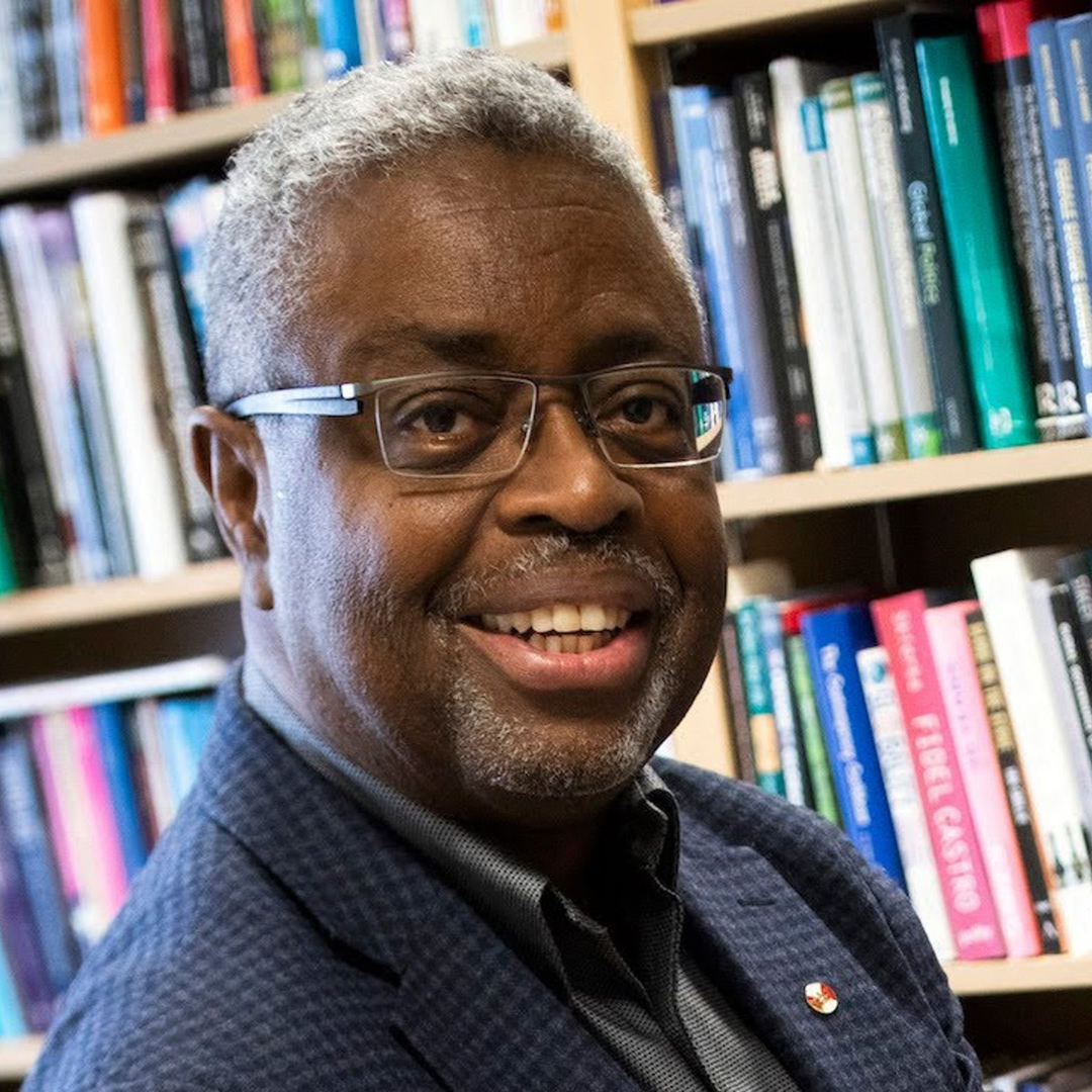 Professor Andy Knight in front of a book case 