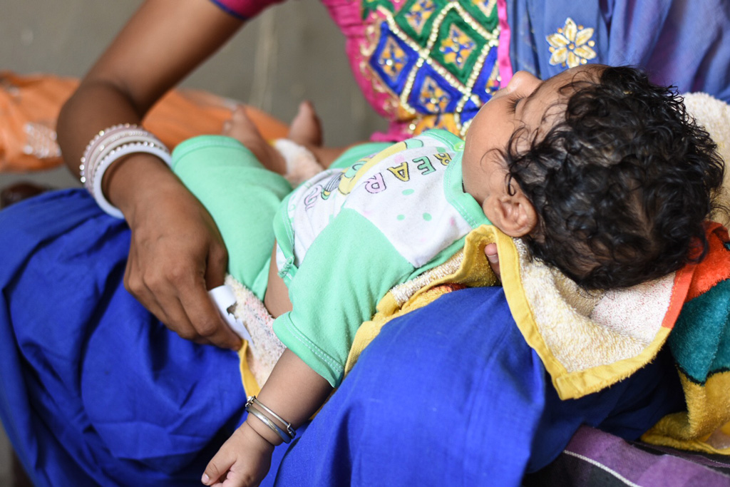 Child sleeping in mother's lap