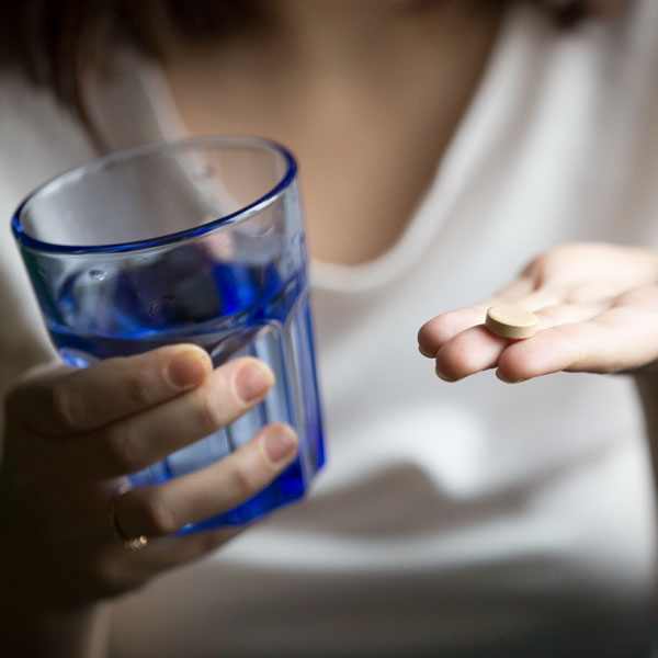 Woman holding water glass.