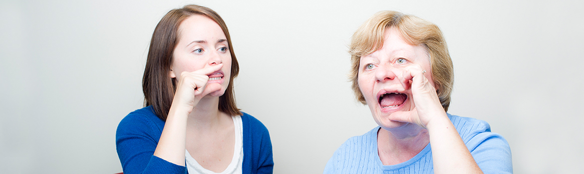 Two people touching their mouths