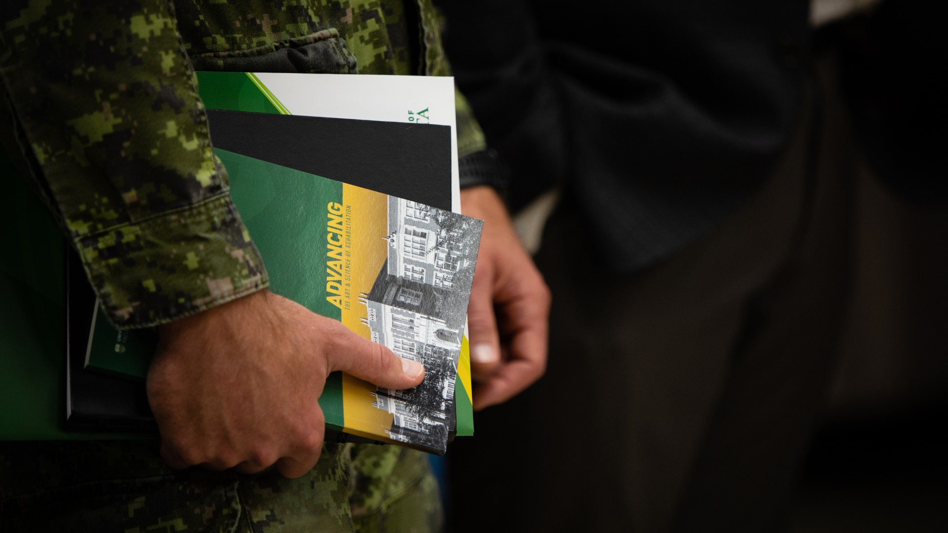 veteran holding books