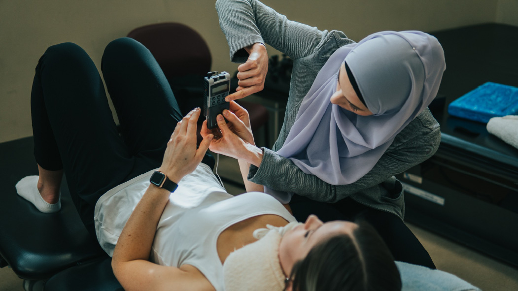 A rehabilitation practitioner working with a patient.