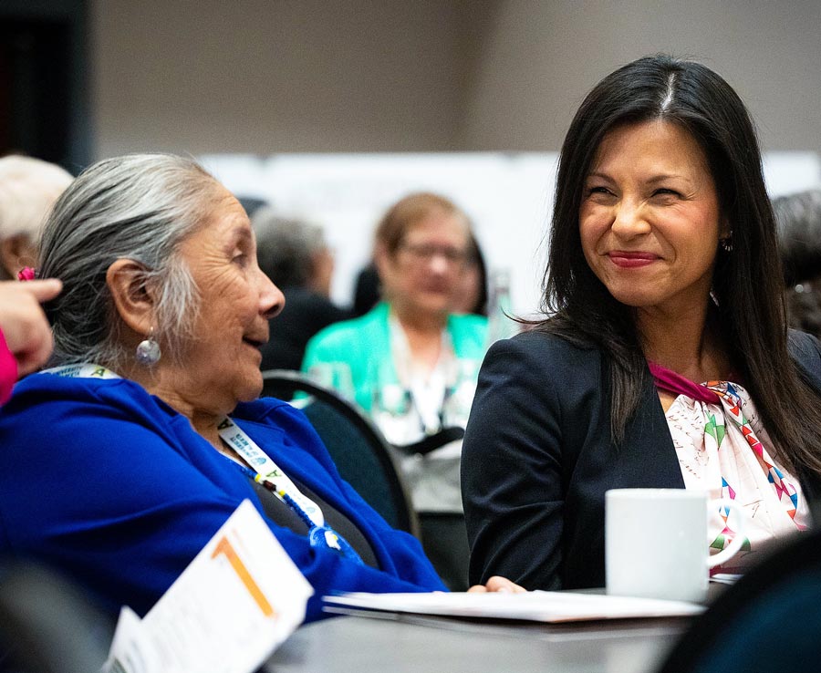 Language advocate Lynda Minoose talks with executive director of Supporting Indigenous Language Revitalization, Pamela McCoy Jones