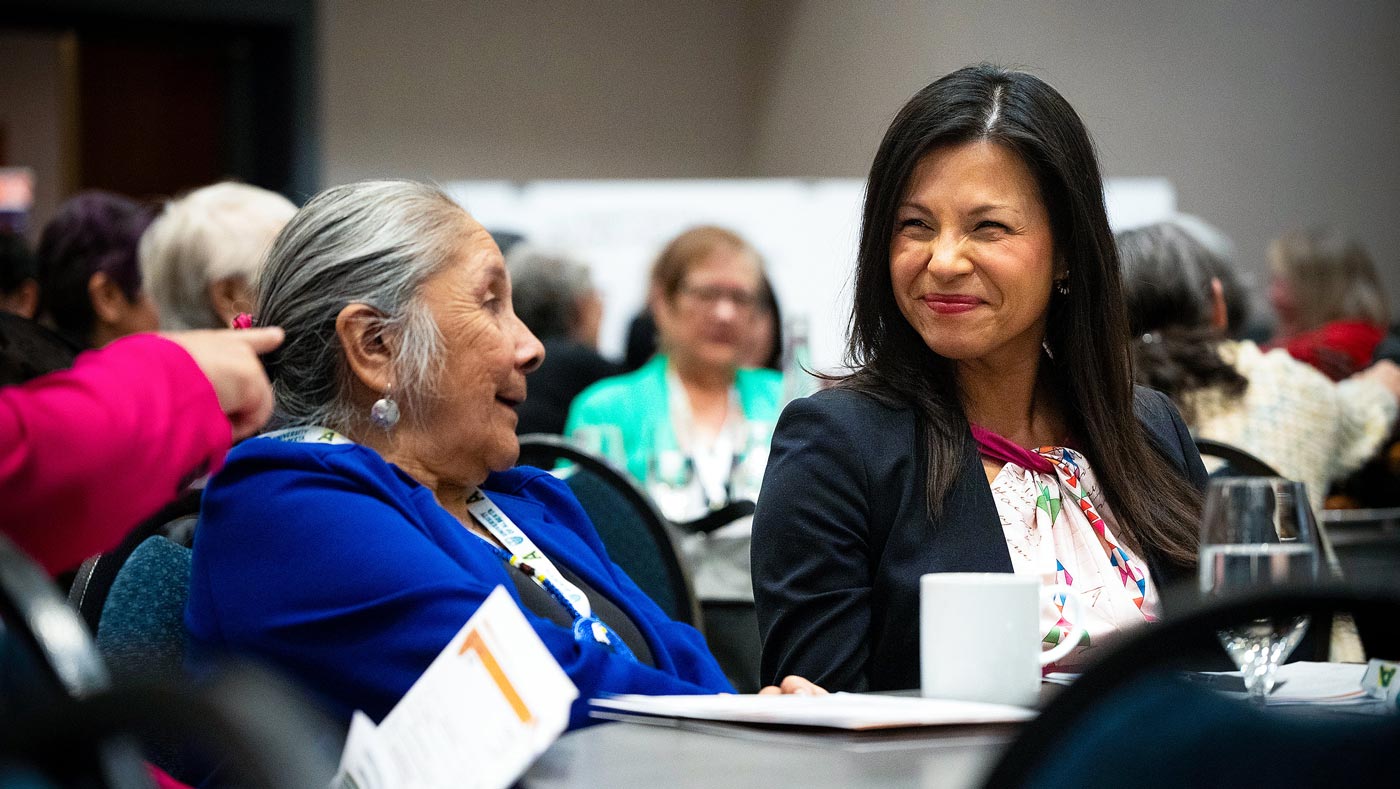 Language advocate Lynda Minoose talks with executive director of Supporting Indigenous Language Revitalization, Pamela McCoy Jones