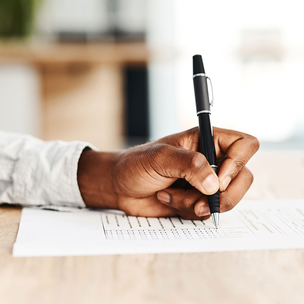 Closeup of a hand signing a paper