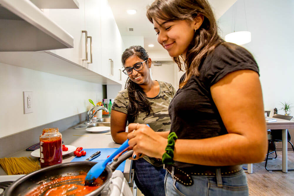 UAlberta student residents cooking in their apartment kitchen