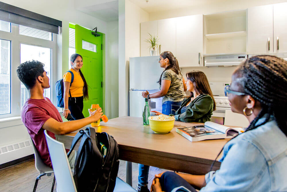 UAlberta student residents sitting in their residence apartment