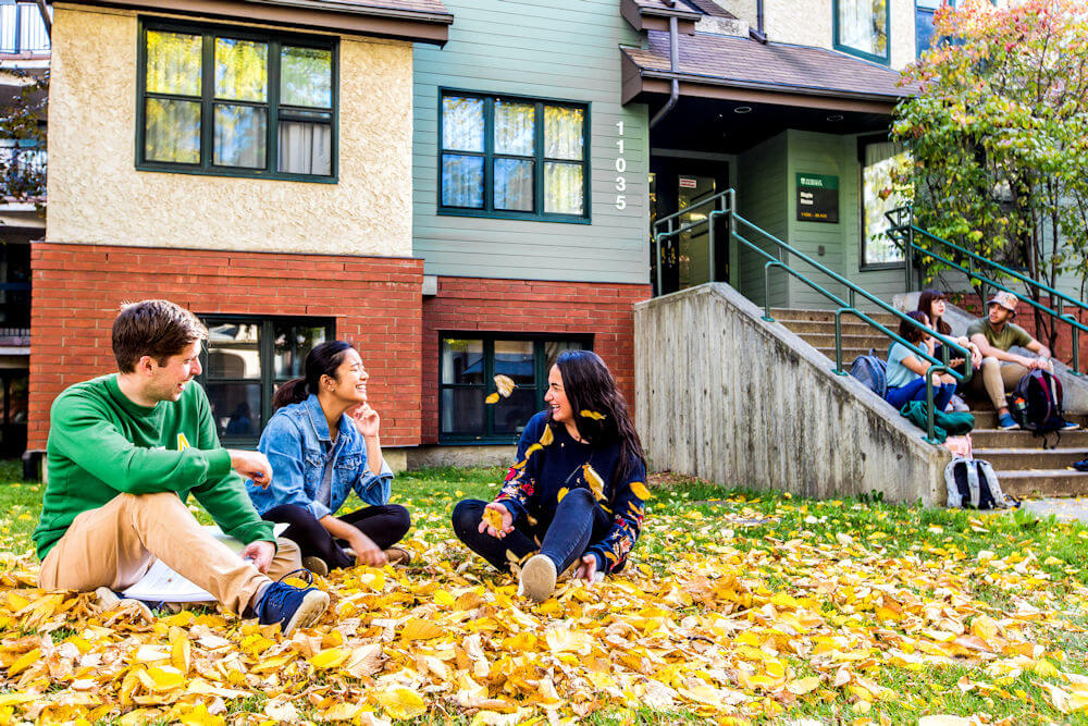 UAlberta student residents sitting on the grass