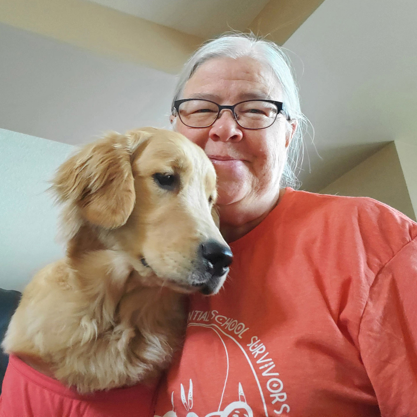 Dr. Gisele Gaudet-Amigo and Luna the dog in their orange shirts