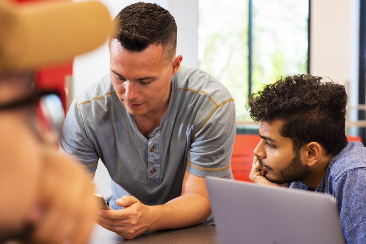 Student Innovation Centre director, Chris Fetterly (left), meets with students to coach them on the resources they can draw on for their ideas.