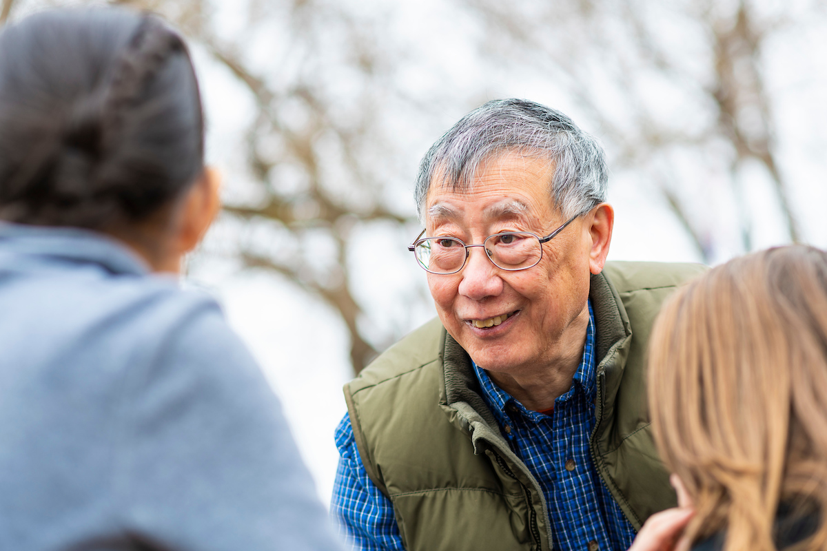 Dan chow, geologist-turned-businessman, smiles while sharing geological samples with 3rd graders from Norwood School