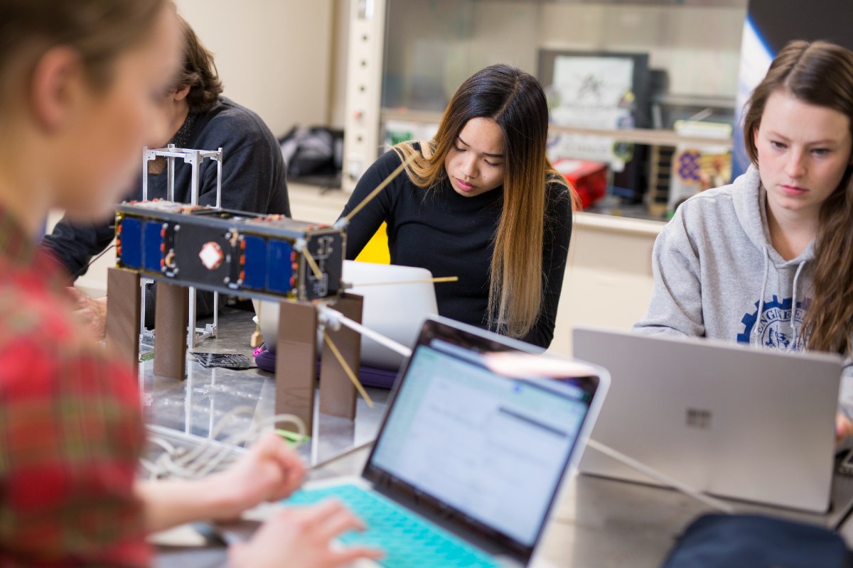 Student group AlbertaSat works on a cube satellite.