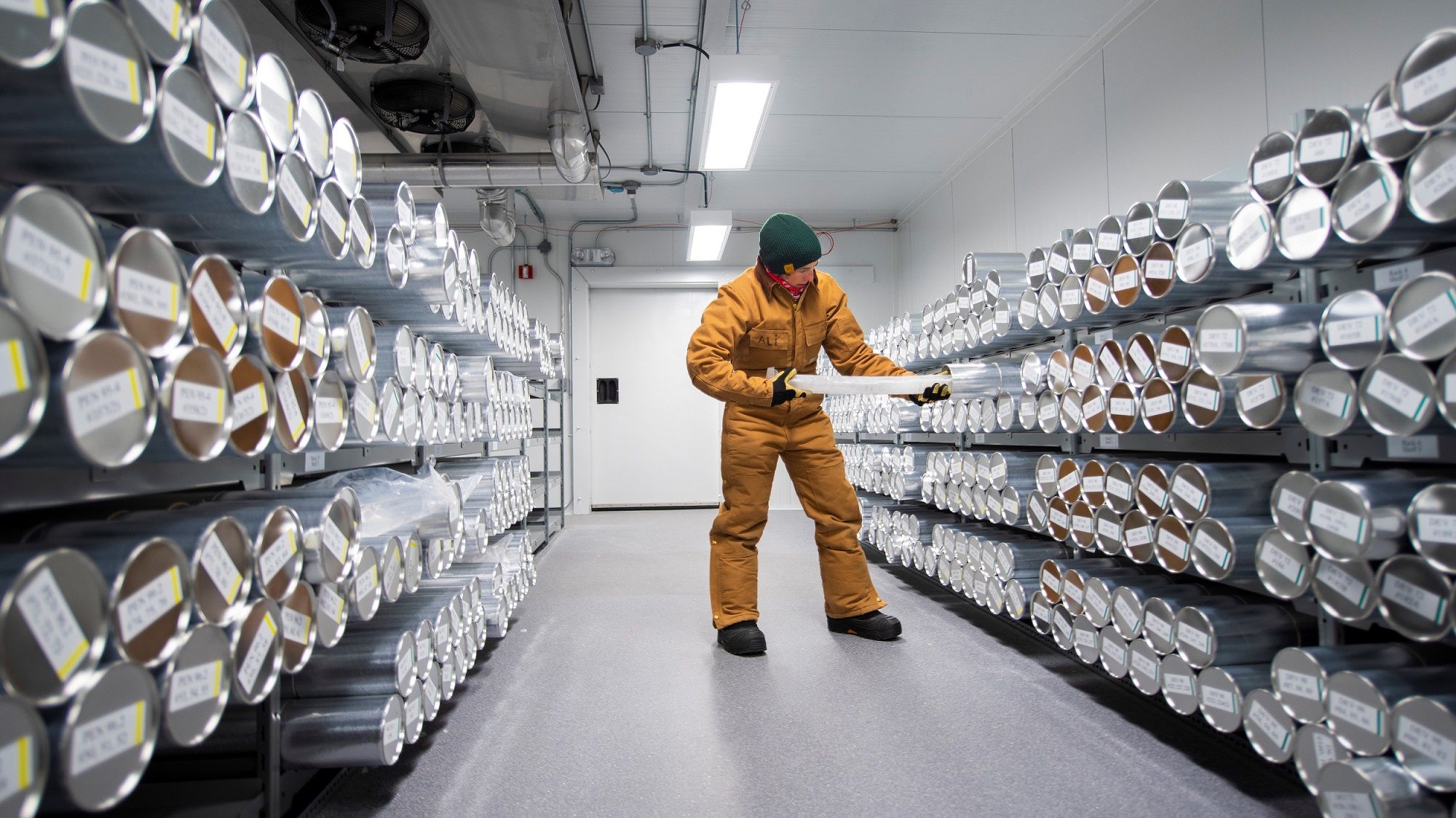 Ali Criscitiello holding an ice core in the ice core archive freezer