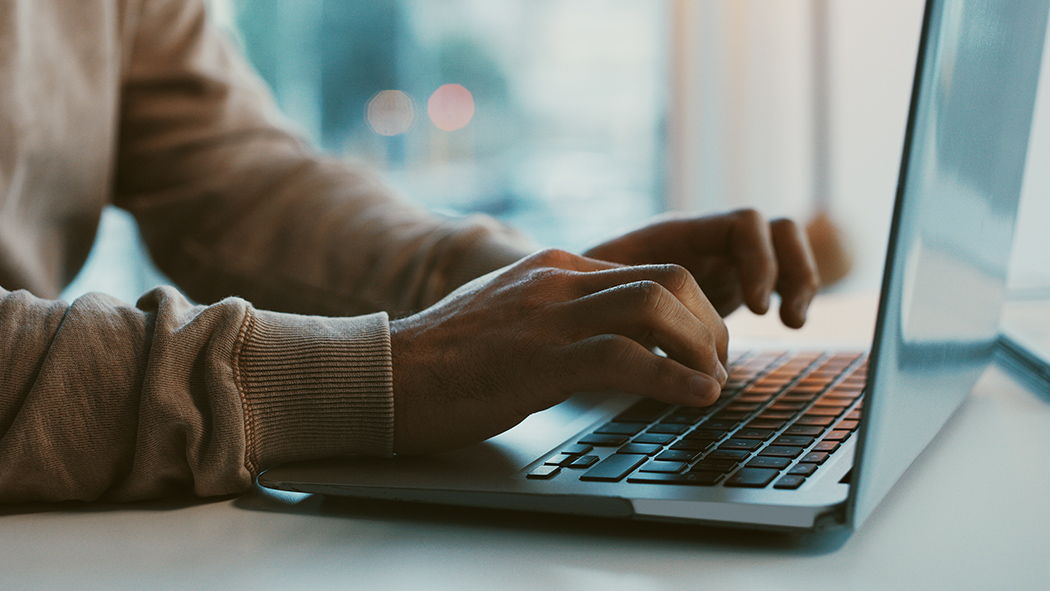 Person typing on keyboard