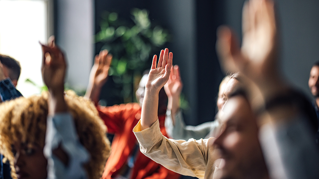 A crowd raising their hands