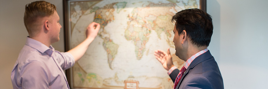 Two men pointing at map