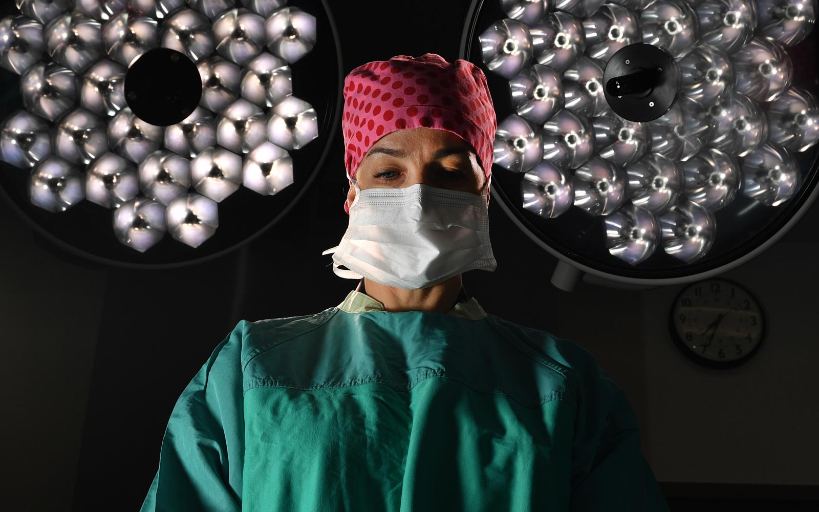 Surgeon conducting surgery with lights behind