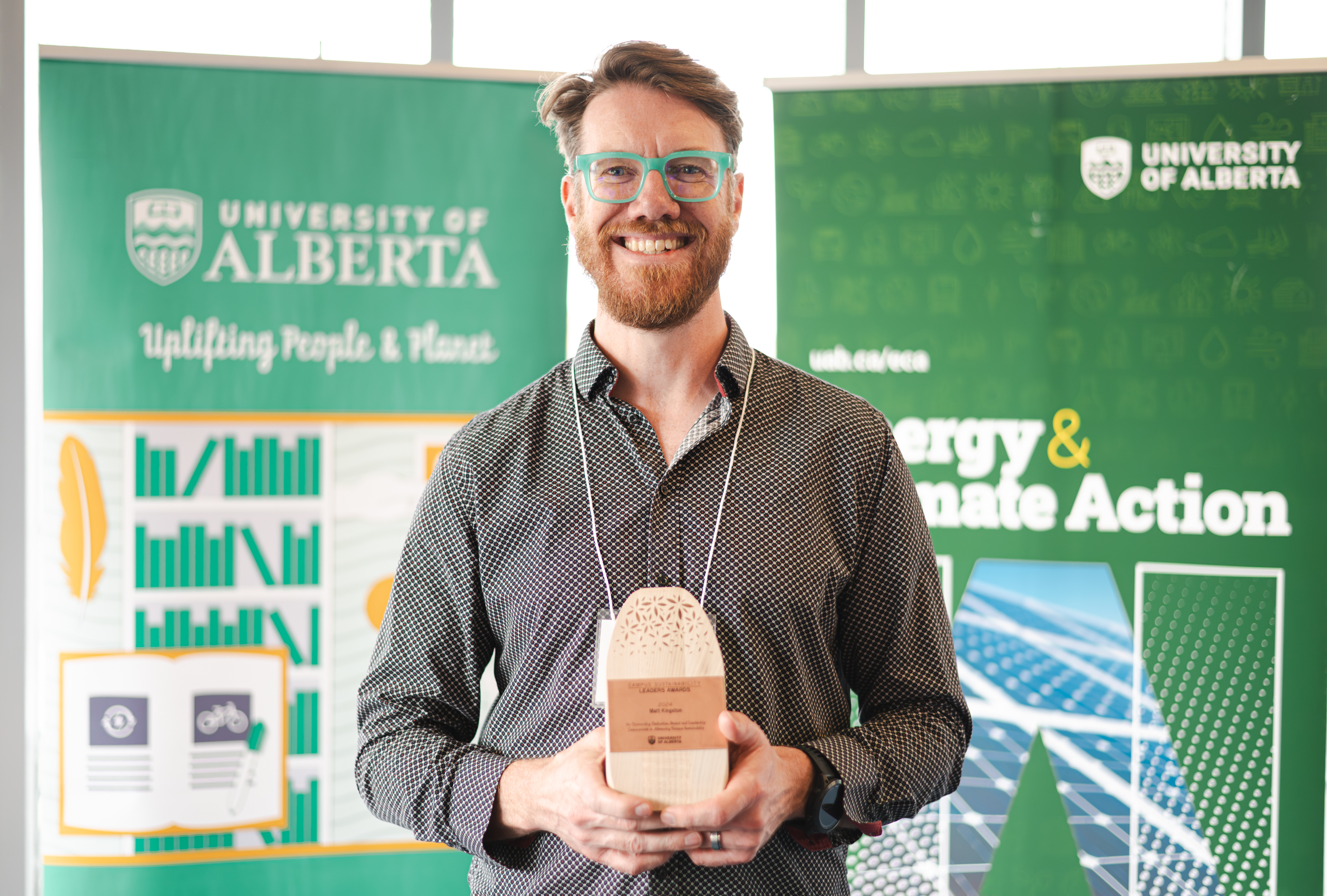 Matt Kingston smiling and holding his trophy