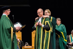 University of Alberta Registrar Lisa Collins invests Chancellor Doug Stollery with his robes of office.