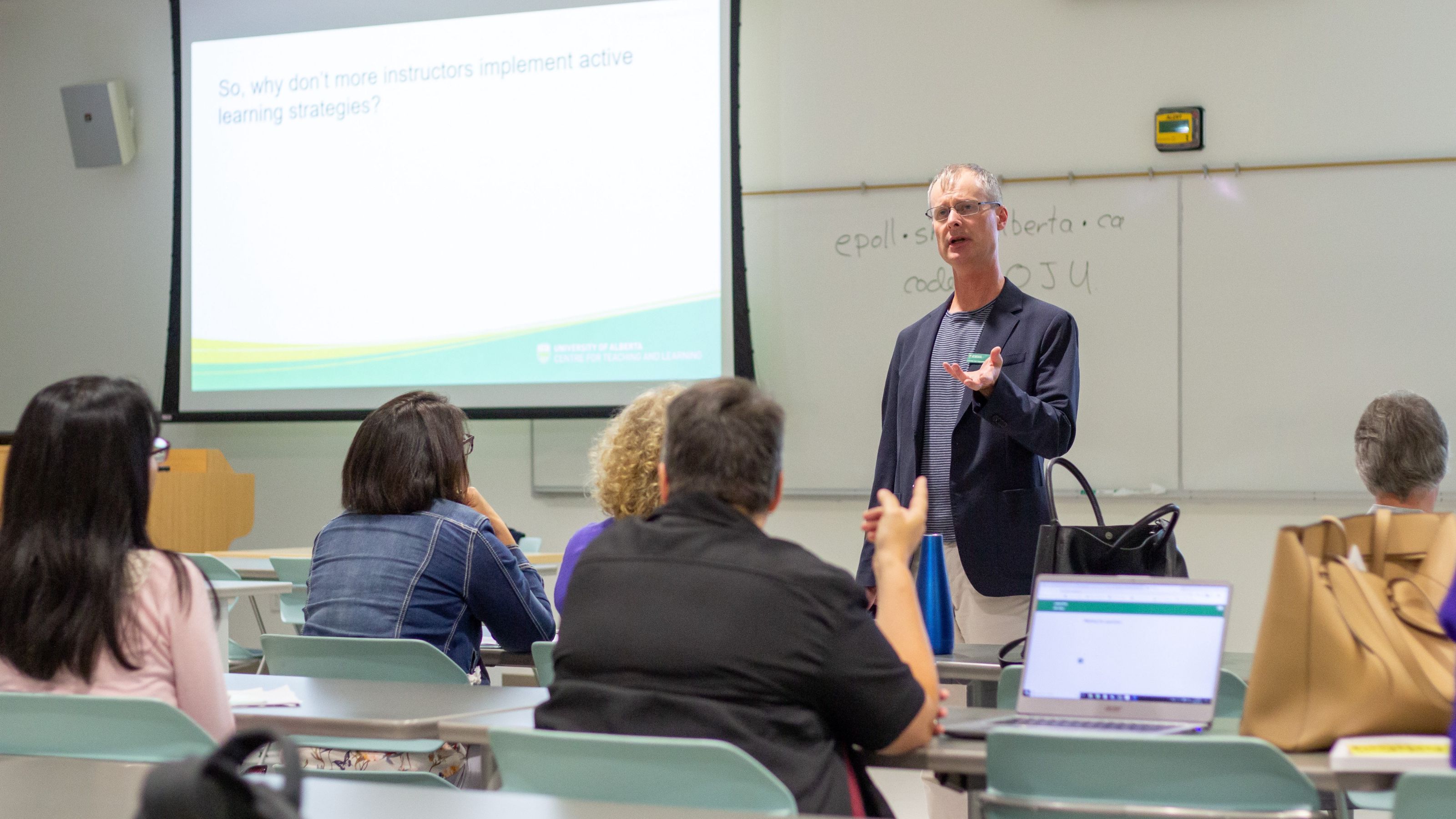 A facilitator is teaching students in a classroom setting