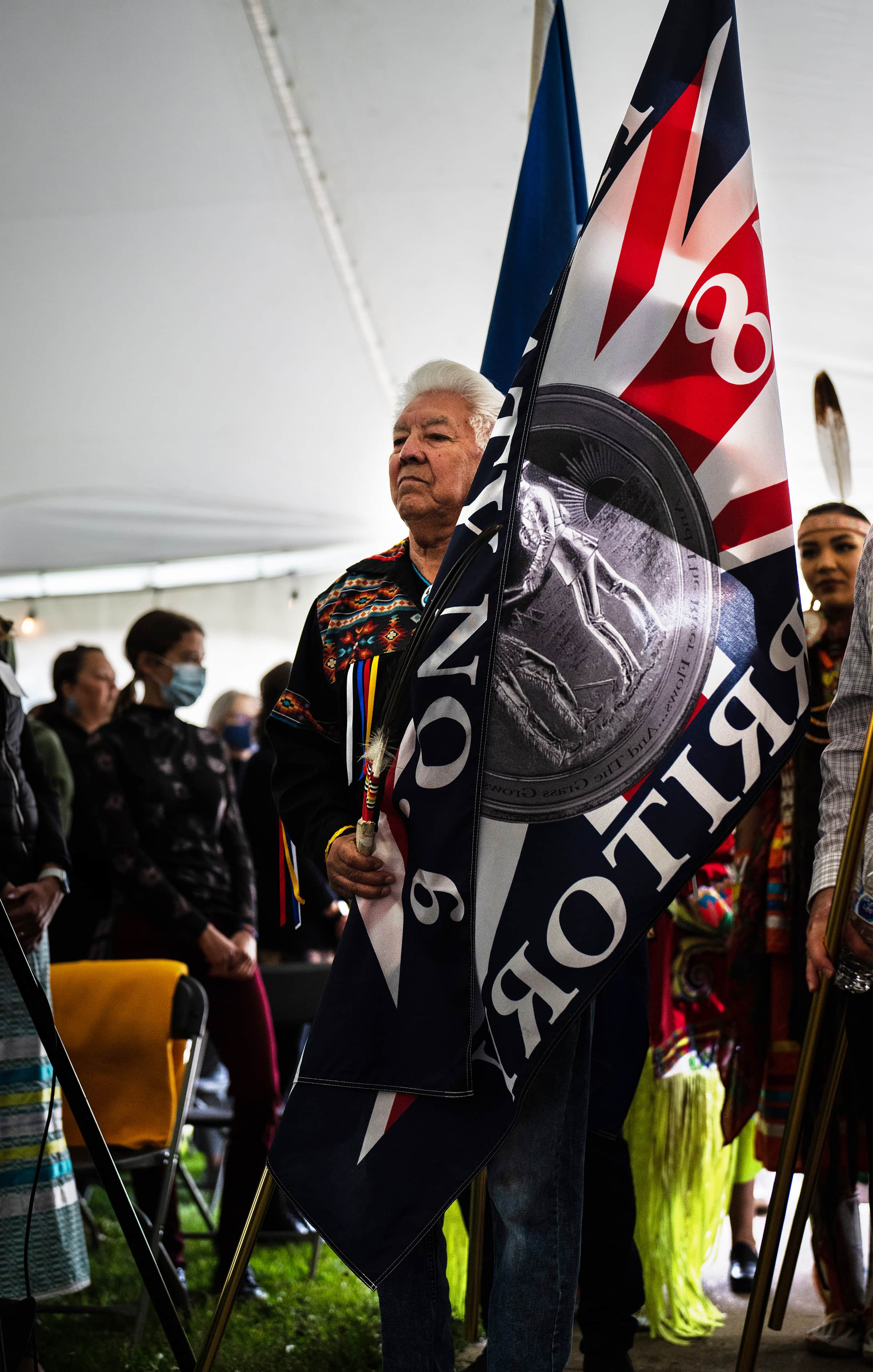 Elder Gilman Cardinal carries the Treaty 6 flag in the Grand Entry.