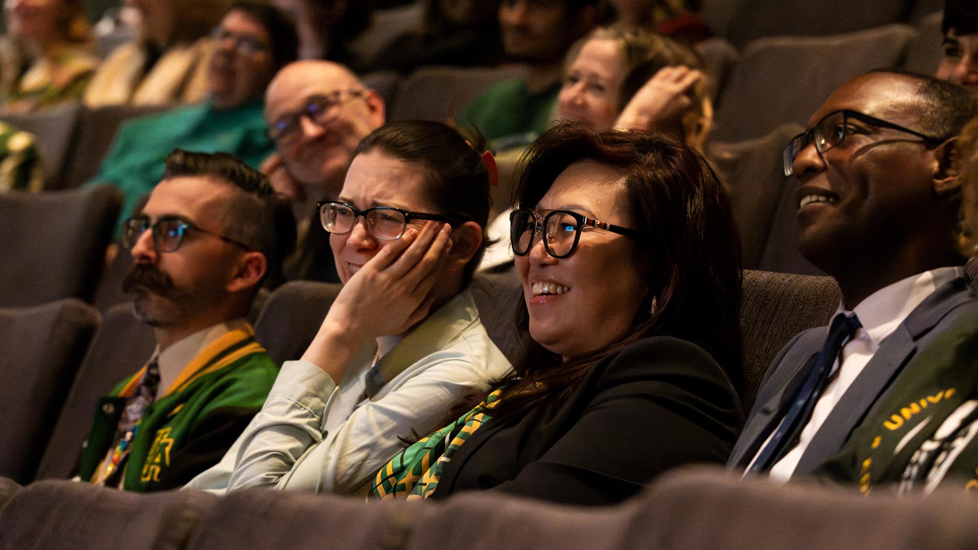 Members of the audience laughing in response to the speakers