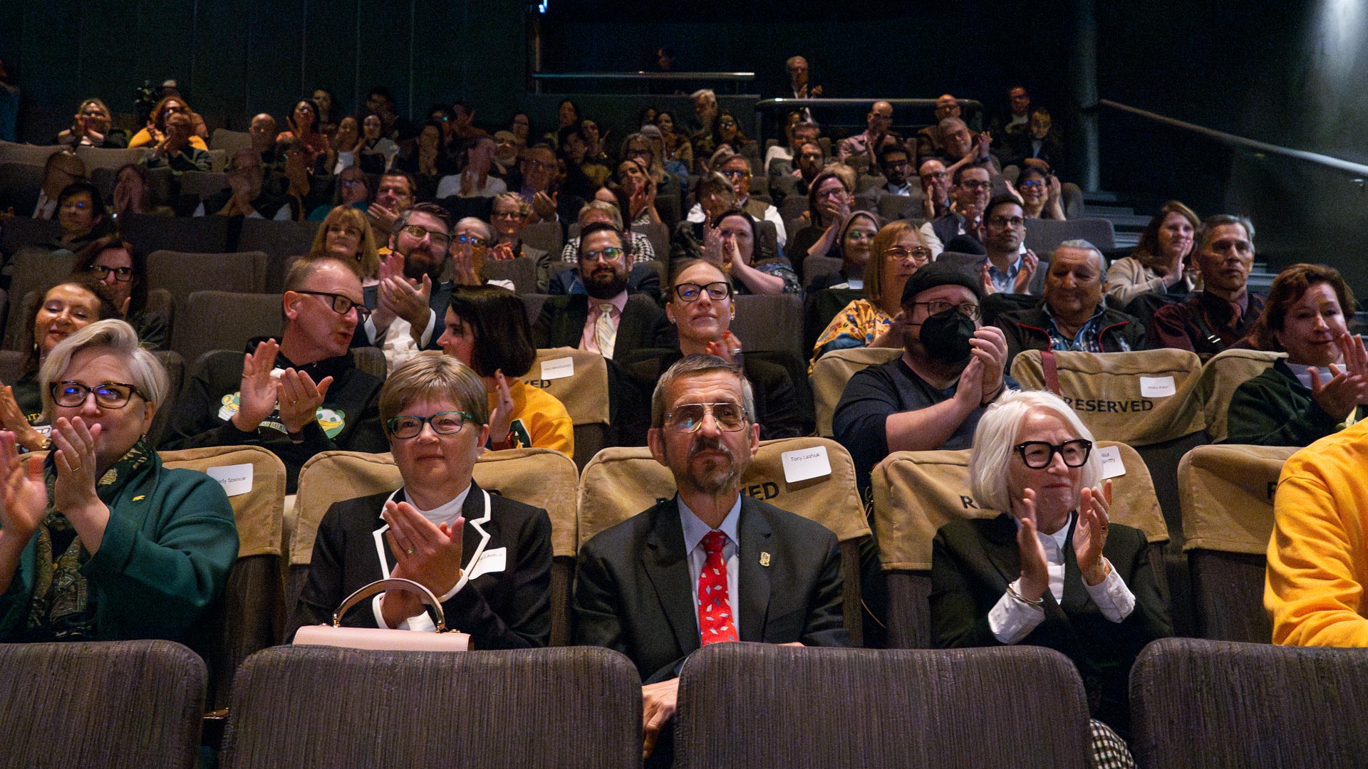 Members of the audience clap