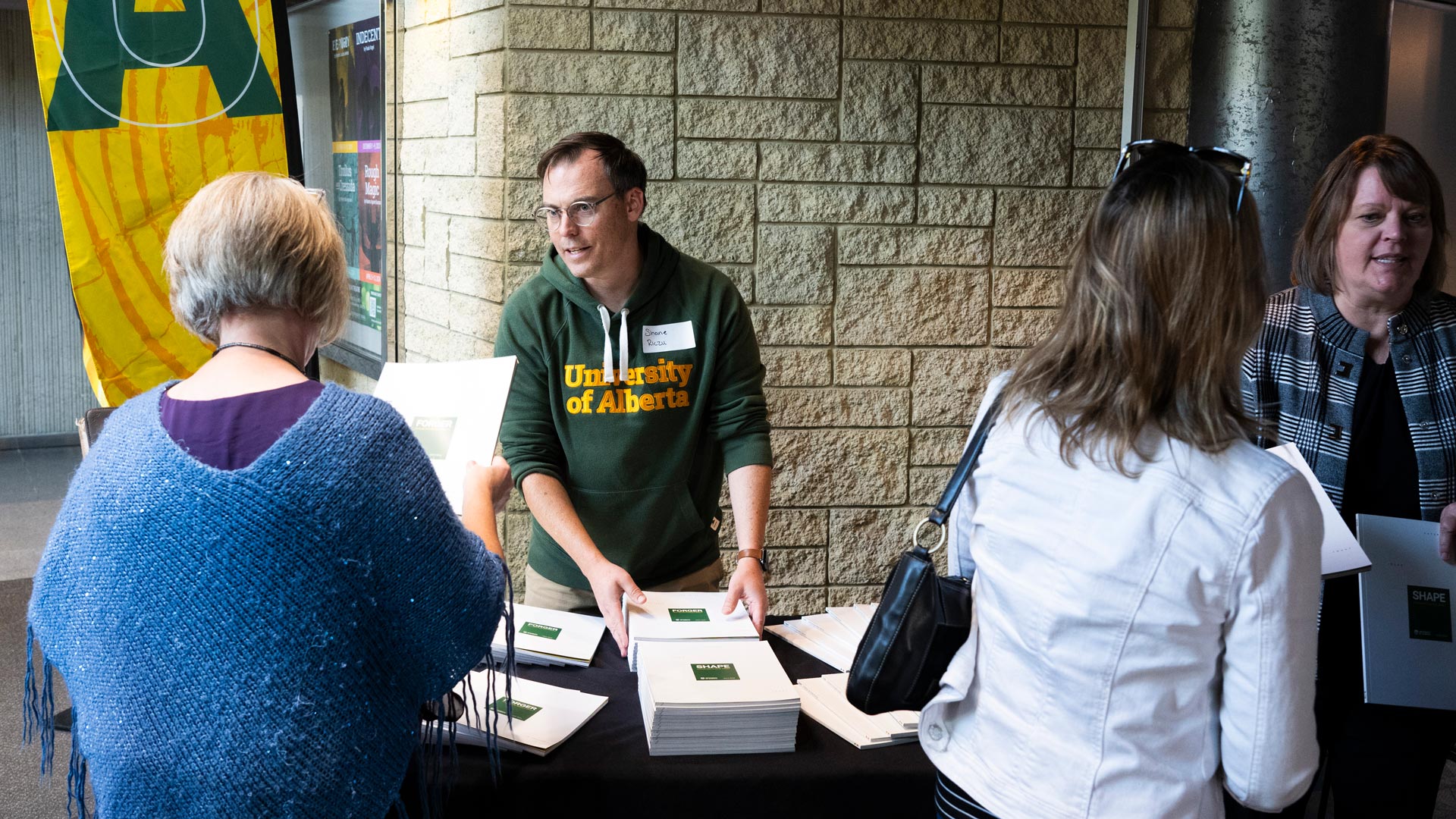 Volunteers hand out copies of the plan