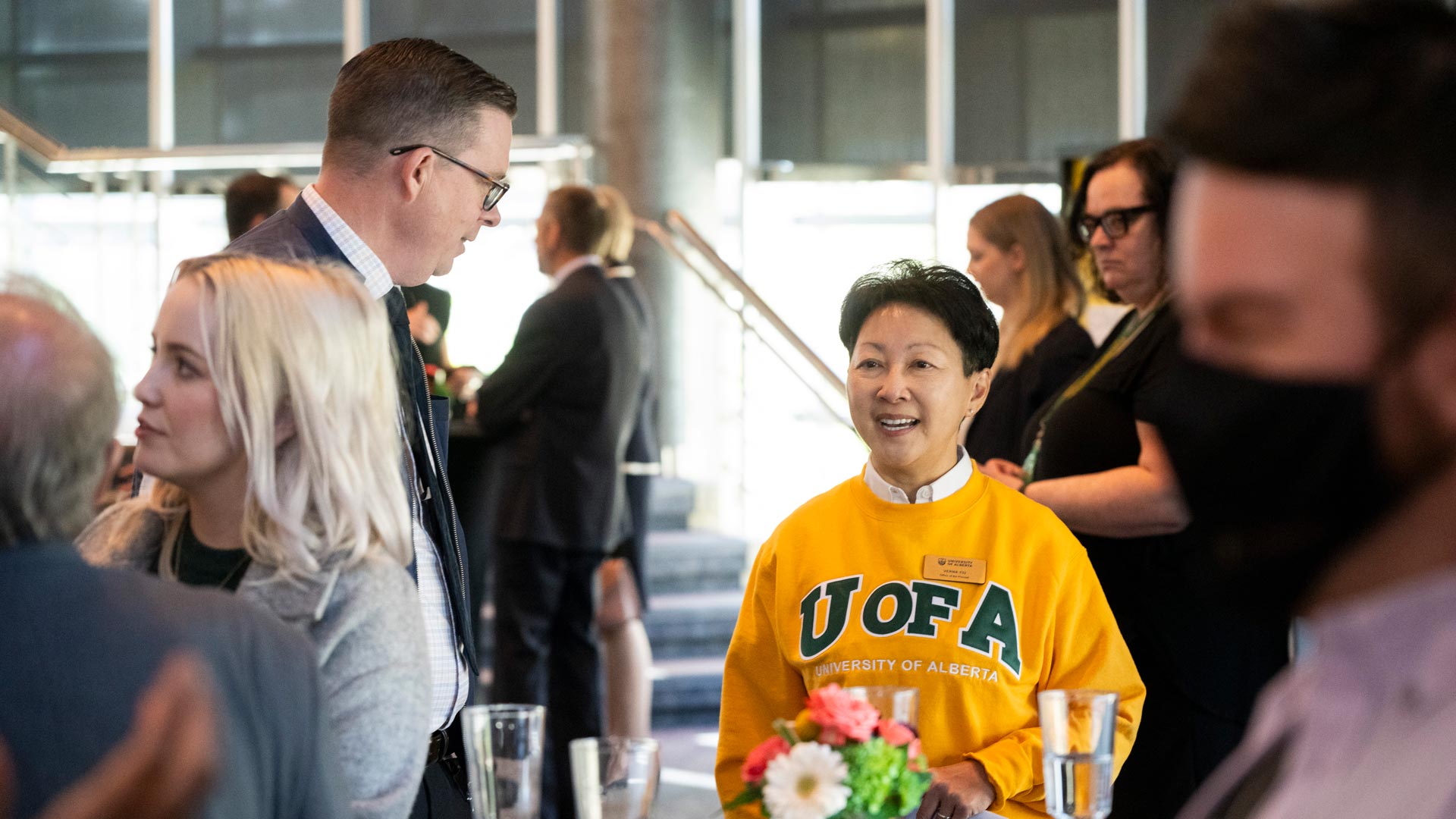 Members of the university community network at the opening reception