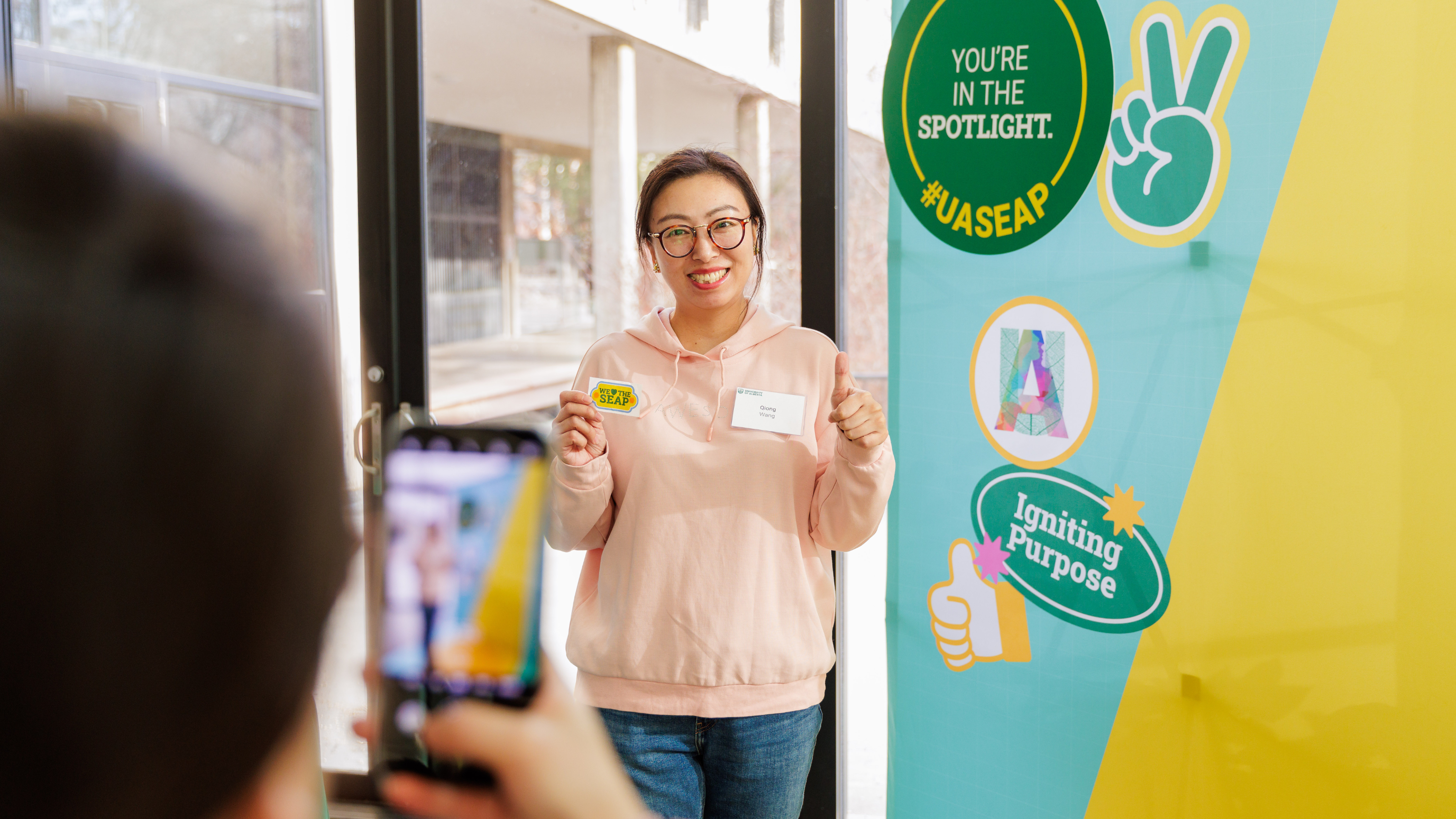 Student getting picture taken at student experience action plan launch.