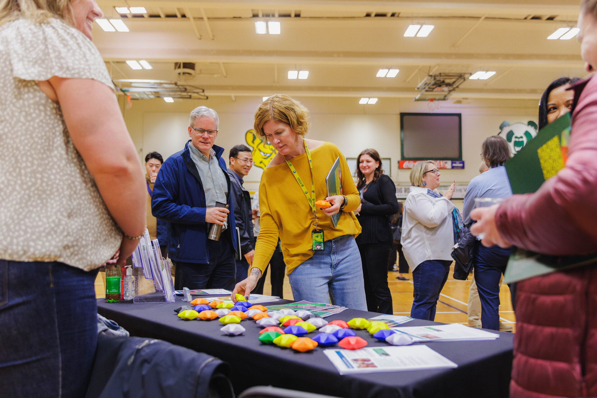 Jill Flaman with External Relations stops by one of the stations representing the theme “Prioritizing Health and Wellbeing.”