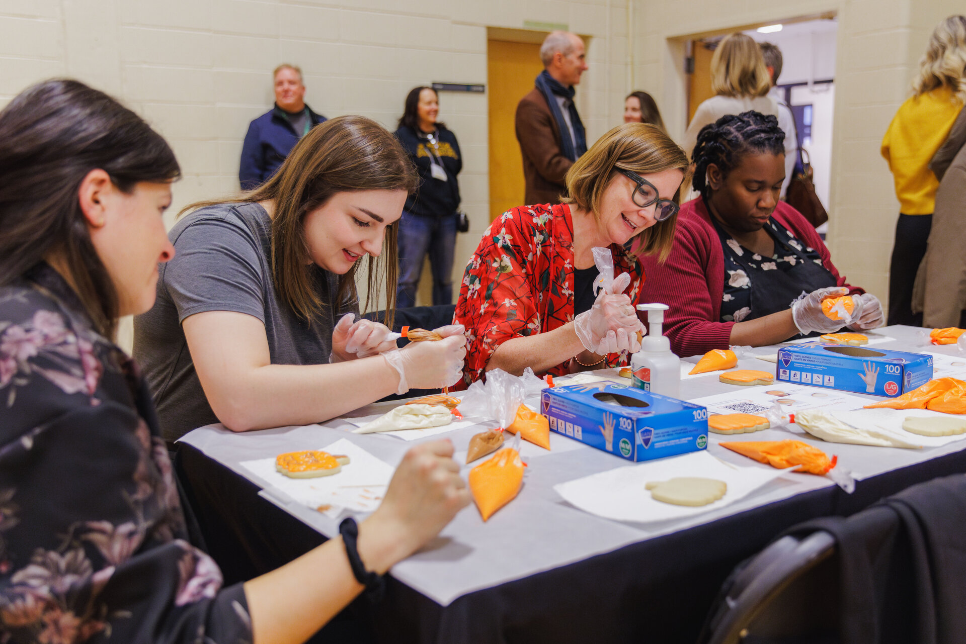 Left to right: Jenn Smyth, Erin Ellis, Tracy Johnson — with F&O — and Blessing Afolayan with the College of Health Sciences take part in the cookie decorating station.