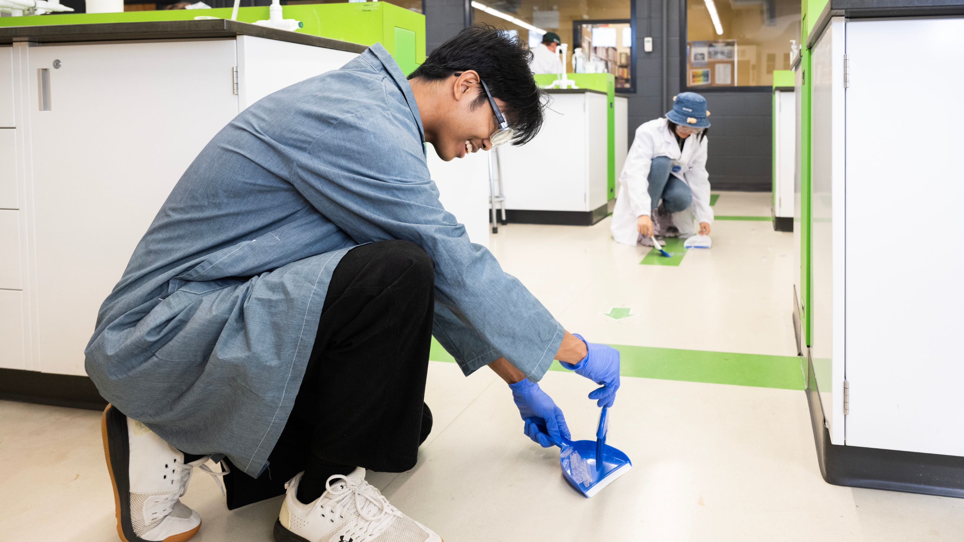 During a class session in Augustana’s AUCHE 351 course, students Lem Pagulayan and Fanxi Sun clean up glass (plastic building material).