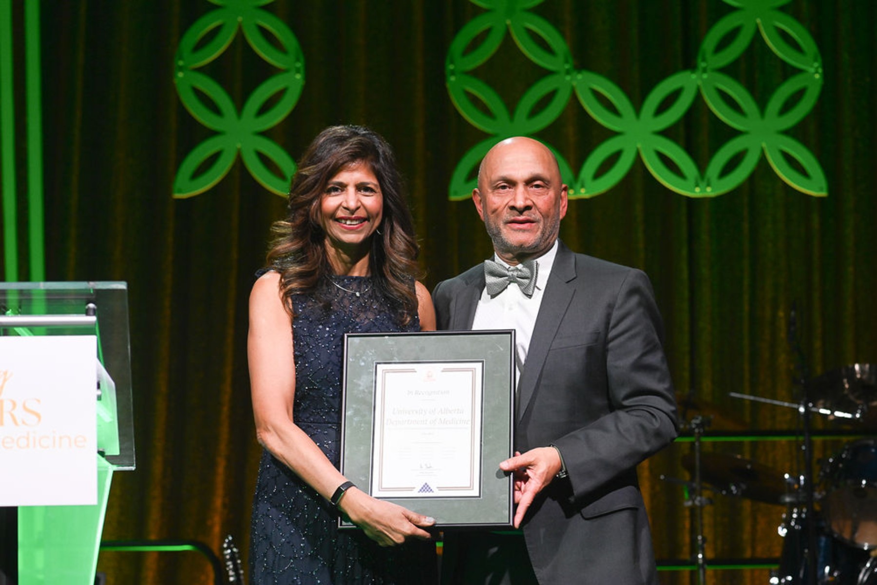 Narmin Kassam, chair of the Department of Medicine, receiving a certificate of department recognition from chancellor Nizar Somji on behalf of mayor Amarjeet Sohi.