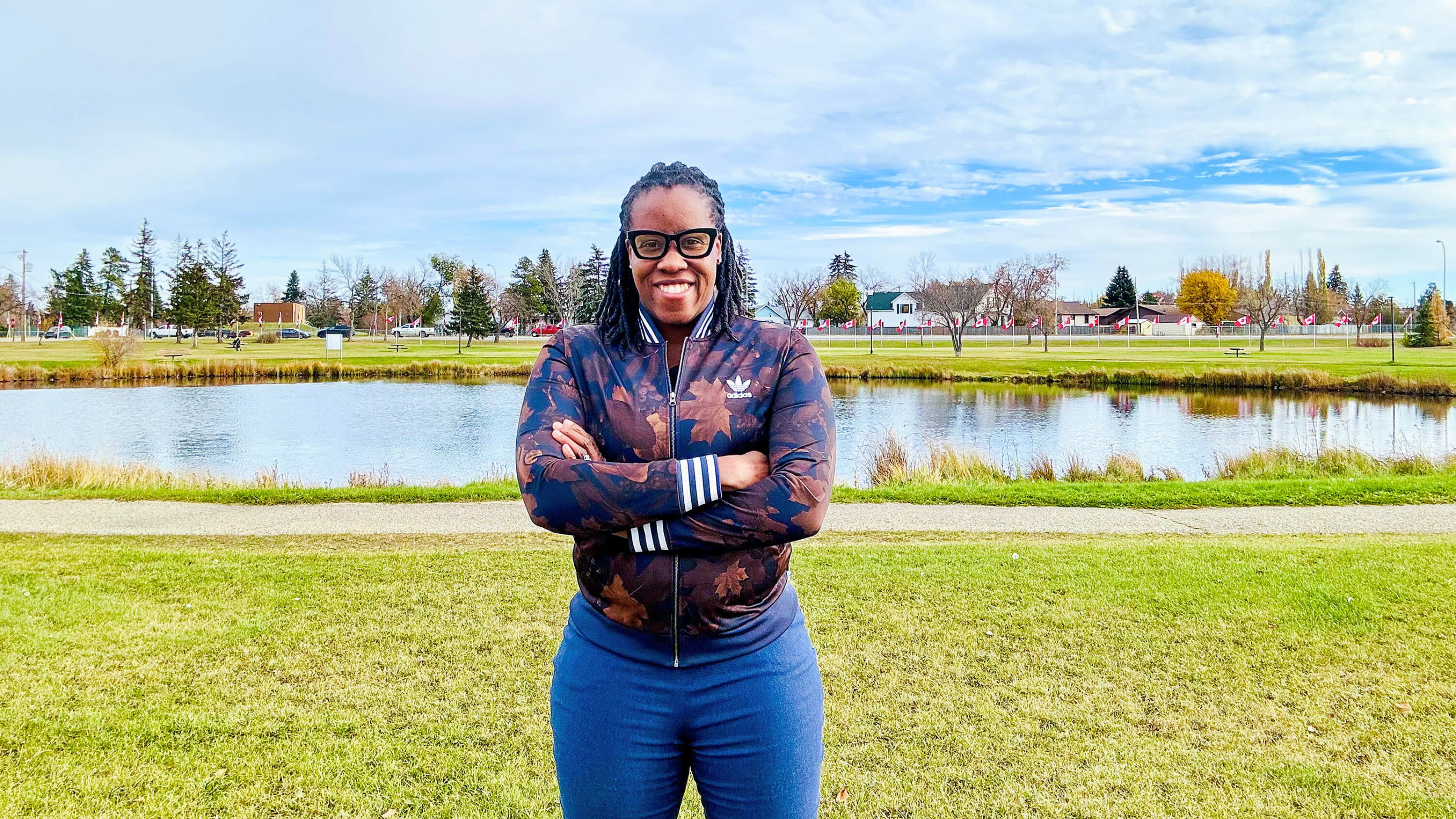 Josephine Godwyll in front of pond, outside in summer.