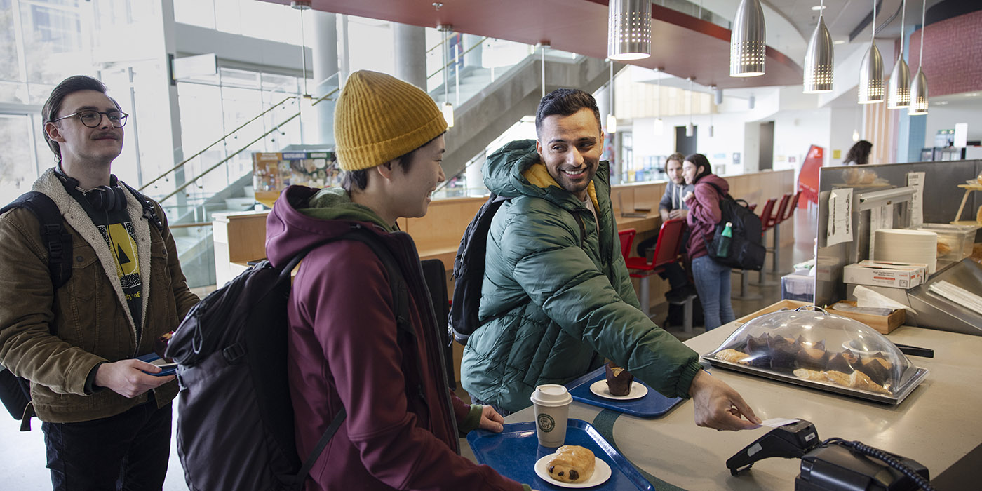 Students paying for their food at a cafeteria on campus