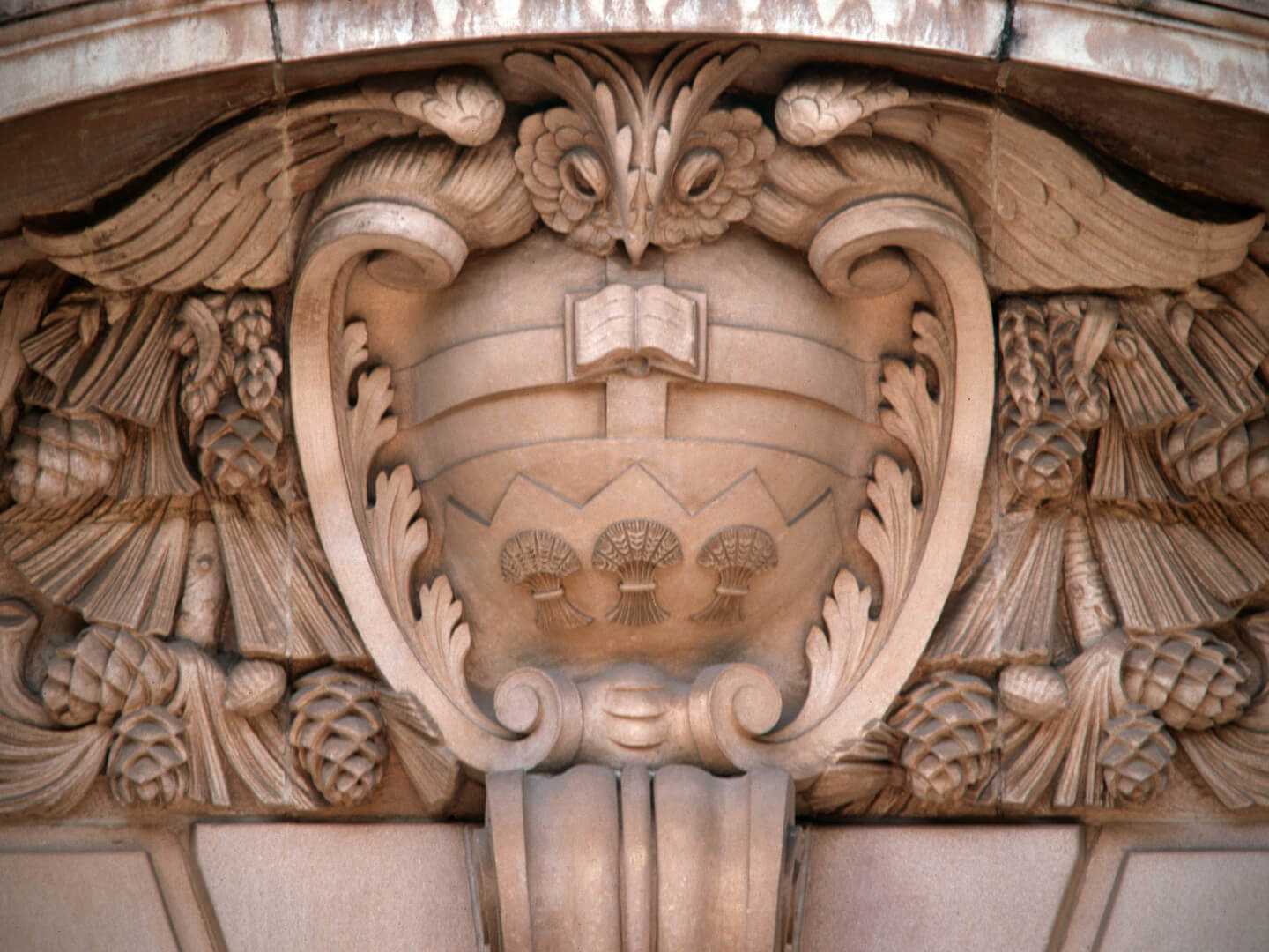 Carved stone own adorning the Arts building